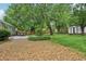 View of the backyard featuring a stone patio, small shed, lush trees, and grass at 1605 Wellswood Se Dr, Atlanta, GA 30315