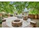 Wonderful backyard offers a stone fire pit, outdoor kitchen, seating, patio, and landscaping at 1605 Wellswood Se Dr, Atlanta, GA 30315