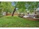 Grassy backyard featuring an outdoor kitchen, patio, fire pit, shed, and wooden fence at 1605 Wellswood Se Dr, Atlanta, GA 30315