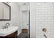 Modern bathroom featuring stylish vanity, sleek fixtures, and contemporary shower with white subway tile at 1605 Wellswood Se Dr, Atlanta, GA 30315