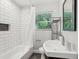 Stylish bathroom features white subway tile, a dark marble niche, and modern fixtures at 1605 Wellswood Se Dr, Atlanta, GA 30315