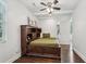 Cozy bedroom features a charming wooden bed with built-in shelving and dark wood floors at 1605 Wellswood Se Dr, Atlanta, GA 30315