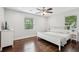 Airy bedroom features hardwood floors, a white bed, and lots of natural light from the windows at 1605 Wellswood Se Dr, Atlanta, GA 30315