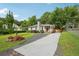 Exterior view of a cozy home with a lush green yard, a quaint front porch, and ample parking space at 1605 Wellswood Se Dr, Atlanta, GA 30315