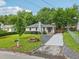 Charming single-story home with a well-manicured lawn, a paved driveway, and blossoming flower beds at 1605 Wellswood Se Dr, Atlanta, GA 30315