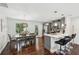 Bright dining area and open kitchen featuring stainless appliances, breakfast bar and hardwood floors at 1605 Wellswood Se Dr, Atlanta, GA 30315