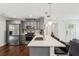 Modern kitchen boasting stainless steel appliances, grey cabinetry, a breakfast bar, and hardwood floors at 1605 Wellswood Se Dr, Atlanta, GA 30315