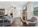 Open-concept living area with hardwood floors, a stone fireplace, and a view to the kitchen at 1605 Wellswood Se Dr, Atlanta, GA 30315