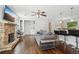Open-concept living area with hardwood floors, a stone fireplace, and a view to the kitchen at 1605 Wellswood Se Dr, Atlanta, GA 30315