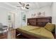 Cozy bedroom featuring a ceiling fan, large window, hardwood floors and ensuite bathroom at 1605 Wellswood Se Dr, Atlanta, GA 30315