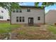 Back exterior of home features a grassy yard and patio area at 1761 Stoney Chase Dr, Lawrenceville, GA 30044