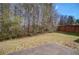Backyard featuring a patio area, grassy lawn, and a wooden privacy fence at 1761 Stoney Chase Dr, Lawrenceville, GA 30044