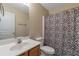 Functional bathroom features a sink, toilet, and shower with patterned curtain, providing essential amenities at 1761 Stoney Chase Dr, Lawrenceville, GA 30044