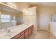 Bright bathroom featuring double sinks, a large mirror, and a separate shower and tub enclosure at 1761 Stoney Chase Dr, Lawrenceville, GA 30044