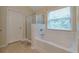 Bright bathroom featuring a tub and shower with clear glass doors, offering a serene bathing experience at 1761 Stoney Chase Dr, Lawrenceville, GA 30044