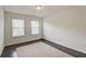 Bright bedroom with hardwood floors and two windows providing natural light at 1761 Stoney Chase Dr, Lawrenceville, GA 30044