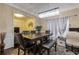 The dining room features a modern chandelier, elegant curtains, and comfortable seating at 1761 Stoney Chase Dr, Lawrenceville, GA 30044
