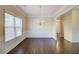 Dining room with hardwood floors, wainscoting, and a modern chandelier at 1761 Stoney Chase Dr, Lawrenceville, GA 30044