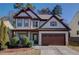 Charming two-story home with a well-maintained front yard and a two-car garage at 1761 Stoney Chase Dr, Lawrenceville, GA 30044