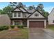 Charming two-story home features a well-manicured lawn and a two-car garage at 1761 Stoney Chase Dr, Lawrenceville, GA 30044