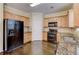 Well-equipped kitchen with wooden cabinets, granite countertops, and modern appliances at 1761 Stoney Chase Dr, Lawrenceville, GA 30044