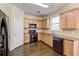 Well-equipped kitchen with wooden cabinets, granite countertops, and black appliances at 1761 Stoney Chase Dr, Lawrenceville, GA 30044