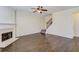 Living room with hardwood floors, fireplace and stairwell to the second floor at 1761 Stoney Chase Dr, Lawrenceville, GA 30044