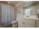 Bright bathroom featuring a vanity with a large mirror and a toilet beside a shower-tub with a black-and-white curtain at 285 Turtle Rock Pl, Acworth, GA 30101