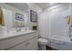 Well-lit bathroom featuring a shower-tub with a white shower curtain and a vanity with a large mirror at 285 Turtle Rock Pl, Acworth, GA 30101