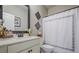 Bathroom features vanity with white countertop, framed mirror, and shower curtain at 285 Turtle Rock Pl, Acworth, GA 30101