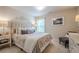 Comfortable bedroom with plush carpet, neutral tones, a decorative headboard, and natural light at 285 Turtle Rock Pl, Acworth, GA 30101