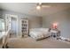 Cozy bedroom with a fan and neutral paint; open to ensuite bathroom with patterned shower curtain at 285 Turtle Rock Pl, Acworth, GA 30101