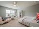 Well-lit bedroom with a ceiling fan, a built-in desk, and an open closet providing ample space at 285 Turtle Rock Pl, Acworth, GA 30101