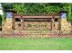 Community entrance featuring stone pillars, a pergola, and lush landscaping, creating a welcoming and grand arrival at 285 Turtle Rock Pl, Acworth, GA 30101