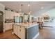 Open kitchen with granite counters, stainless appliances and kitchen island overlooking a large seating area at 285 Turtle Rock Pl, Acworth, GA 30101