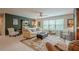 Spacious living room featuring an accent wall, neutral sofa and chairs, a ceiling fan, and a floral area rug at 285 Turtle Rock Pl, Acworth, GA 30101