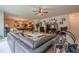 Spacious living room with a comfortable leather sofa, ceiling fan, and recreational games at 285 Turtle Rock Pl, Acworth, GA 30101