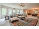 Expansive living room featuring a sectional sofa, ample natural light, and an adjacent dining and game area at 285 Turtle Rock Pl, Acworth, GA 30101