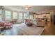Spacious living room with a large sofa, hardwood floors, and access to the kitchen at 285 Turtle Rock Pl, Acworth, GA 30101