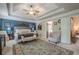 Relaxing main bedroom with a tray ceiling, large rug, access to ensuite bathroom, and large windows at 285 Turtle Rock Pl, Acworth, GA 30101