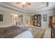 Main bedroom with large area rug, ensuite access, tray ceiling, and walk-in closet with armoire at 285 Turtle Rock Pl, Acworth, GA 30101
