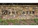Stone entrance sign for Bentwater Community showcases manicured landscaping adding a touch of elegance to the neighborhood at 285 Turtle Rock Pl, Acworth, GA 30101