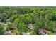 Aerial view showcases this home surrounded by mature trees in a quiet residential neighborhood at 3780 Bays Ferry Way, Marietta, GA 30062