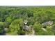 Aerial view of a home nestled in a lush, green, tree-filled neighborhood offering privacy and tranquility at 3780 Bays Ferry Way, Marietta, GA 30062