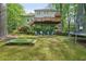 Expansive backyard features a putting green, multiple decks, and recreational space for outdoor activities at 3780 Bays Ferry Way, Marietta, GA 30062