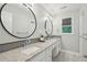 Modern bathroom featuring double sinks, granite countertops, and stylish mirrors at 3780 Bays Ferry Way, Marietta, GA 30062