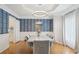 Elegant dining room features a modern chandelier and stylish blue wallpaper with white trim at 3780 Bays Ferry Way, Marietta, GA 30062