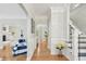 Inviting foyer boasts hardwood floors, arched doorways, and staircase with black and white accents at 3780 Bays Ferry Way, Marietta, GA 30062