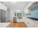 Kitchen features white cabinetry, stainless appliances, quartz countertops, and tile backsplash at 3780 Bays Ferry Way, Marietta, GA 30062