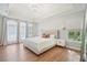 Spacious primary bedroom featuring a tray ceiling and lots of natural light from large windows at 3780 Bays Ferry Way, Marietta, GA 30062
